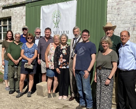 A group of people standing in front of a building Holme Farm Community Gardens & Workshops
